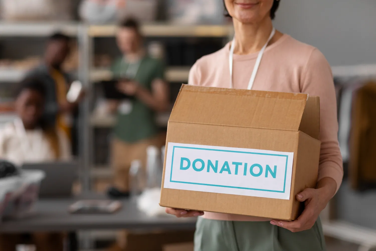 2149230501 Volunteer helping with donation box<br />